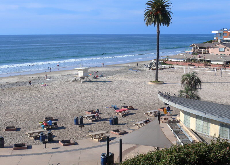 Moonlight State Beach, concessions, rentals, restrooms in the foreground with picnic tables and fire pits